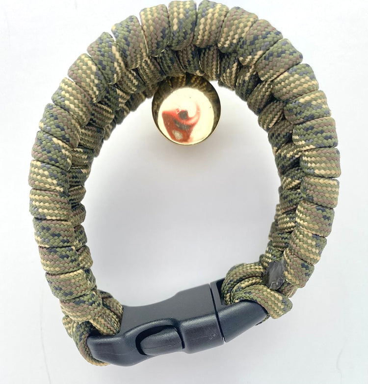 a bracelet made out of camo paracord and a black buckle