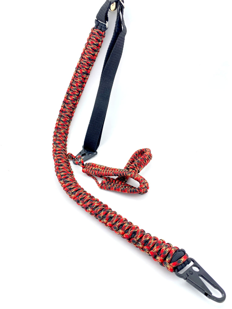 a no-drill rifle sling made in red, tan, and black patterned 550 paracord and black hardware and webbing