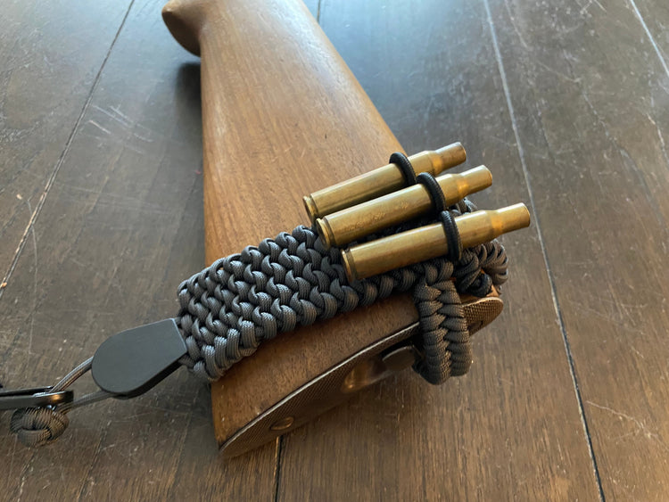 a handmade adjustable rifle stock band made out of black paracord
