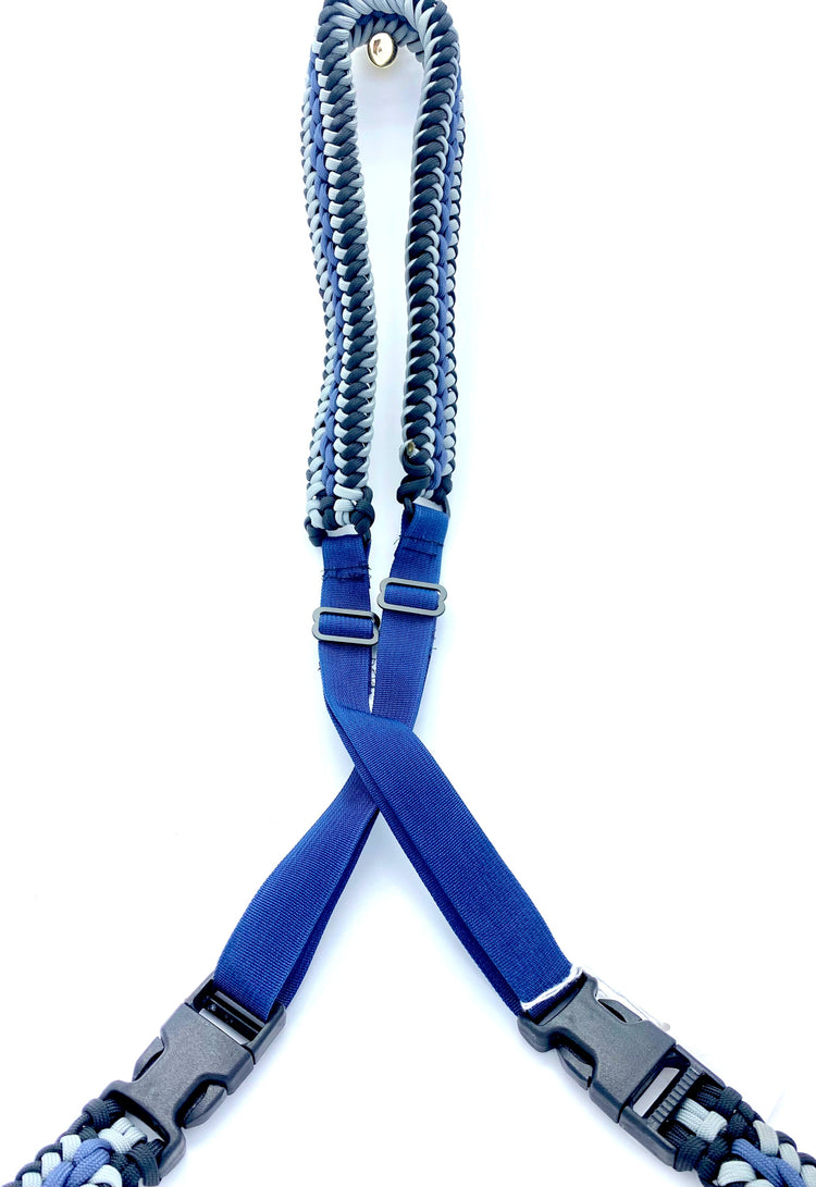 a sanctified-woven bow sling made with black, gray, and navy paracord, navy webbing, and black hardware