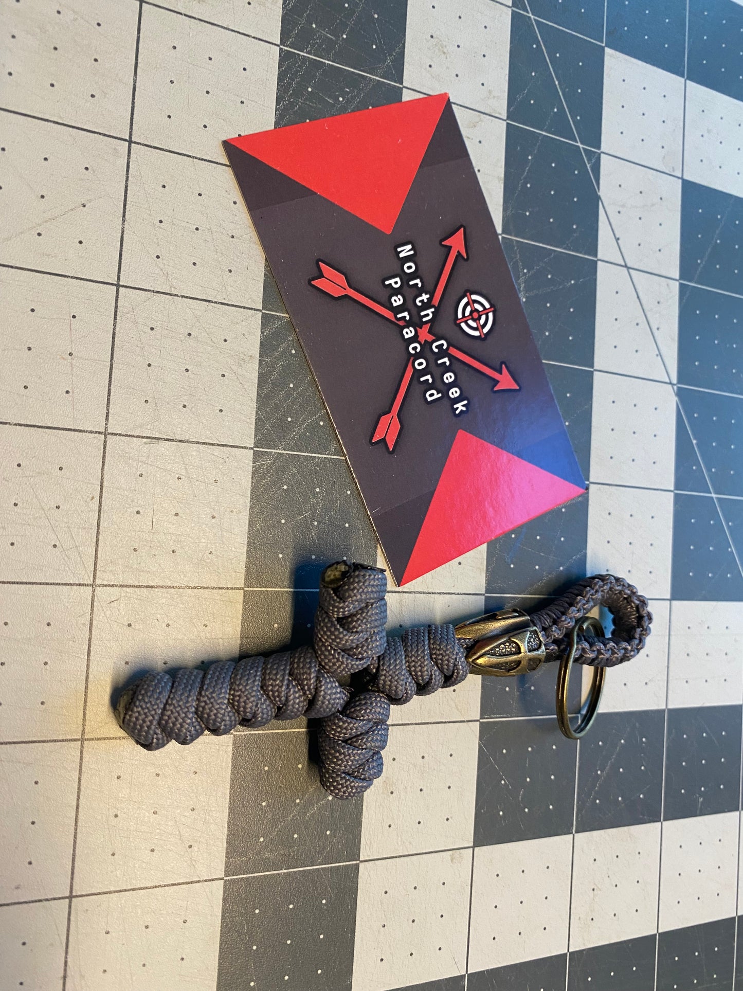 a key fob made with a lanyard bead and a snake knot cross