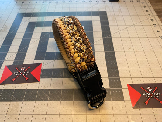 a pet collar built in the modified sanctified weave in tan, brown, black, and white hues