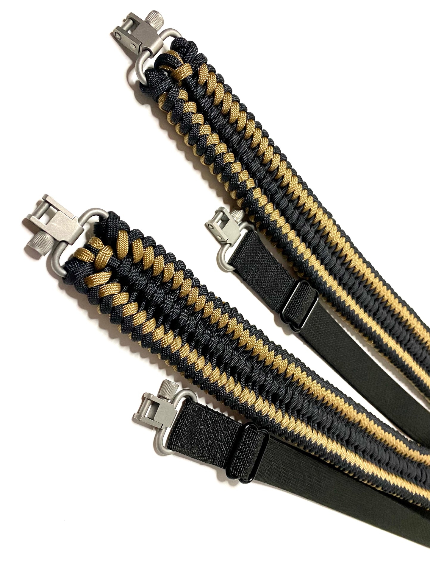 two rifle slings made in the sanctified covenant weave with black and tan paracord, black webbing and silver trilock swivels.