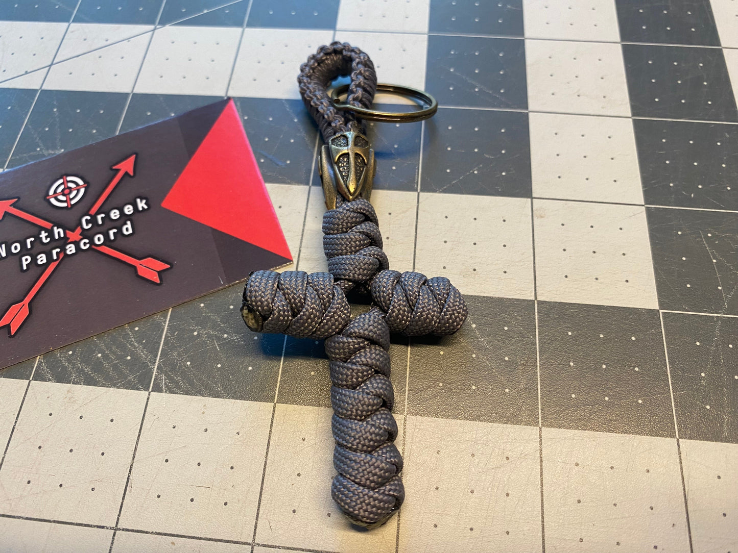 a key fob built with a lanyard bead and a snake knot cross