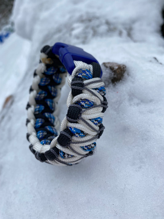 a soloman's dragon bracelet made in white, black and blue paracord