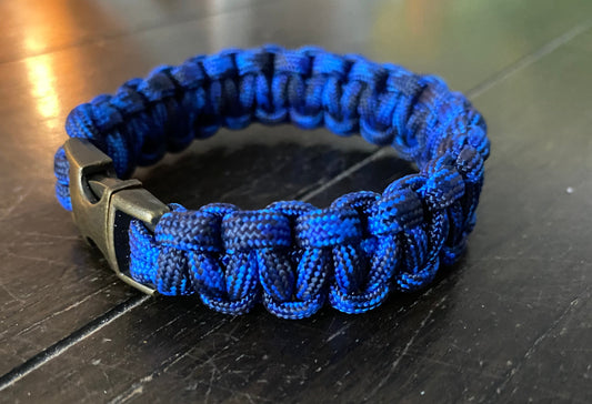 a cobra paracord bracelet crafted using a brass buckle