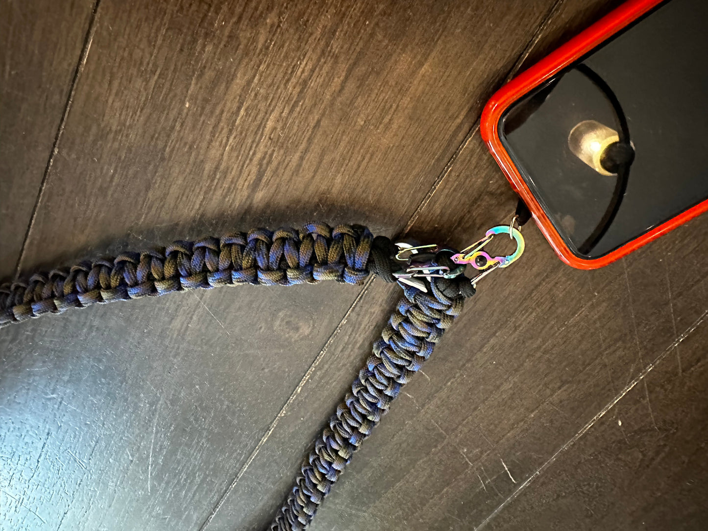 a cross body paracord lanyard attached to a phone