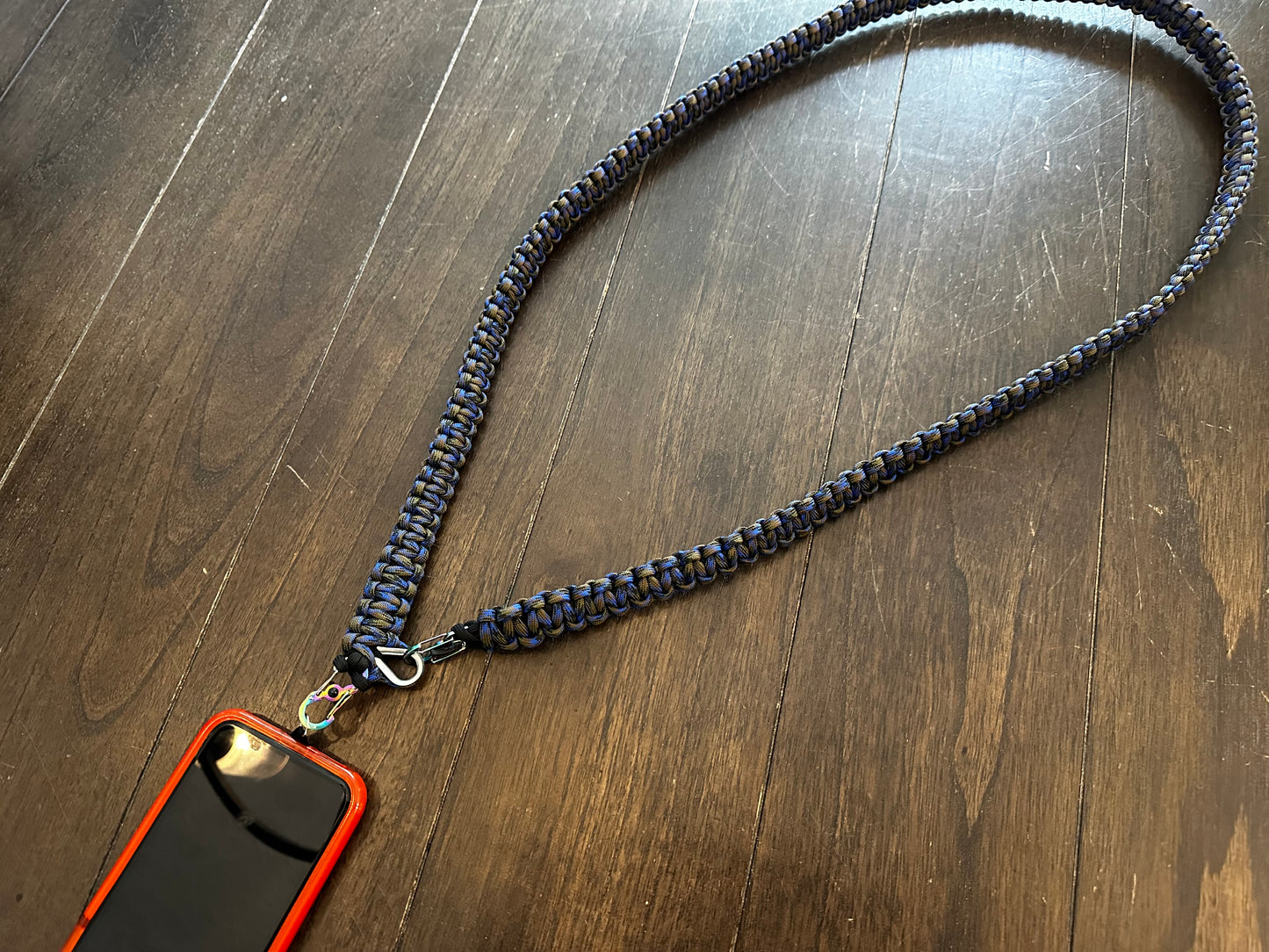 a cross body paracord lanyard attached to a phone