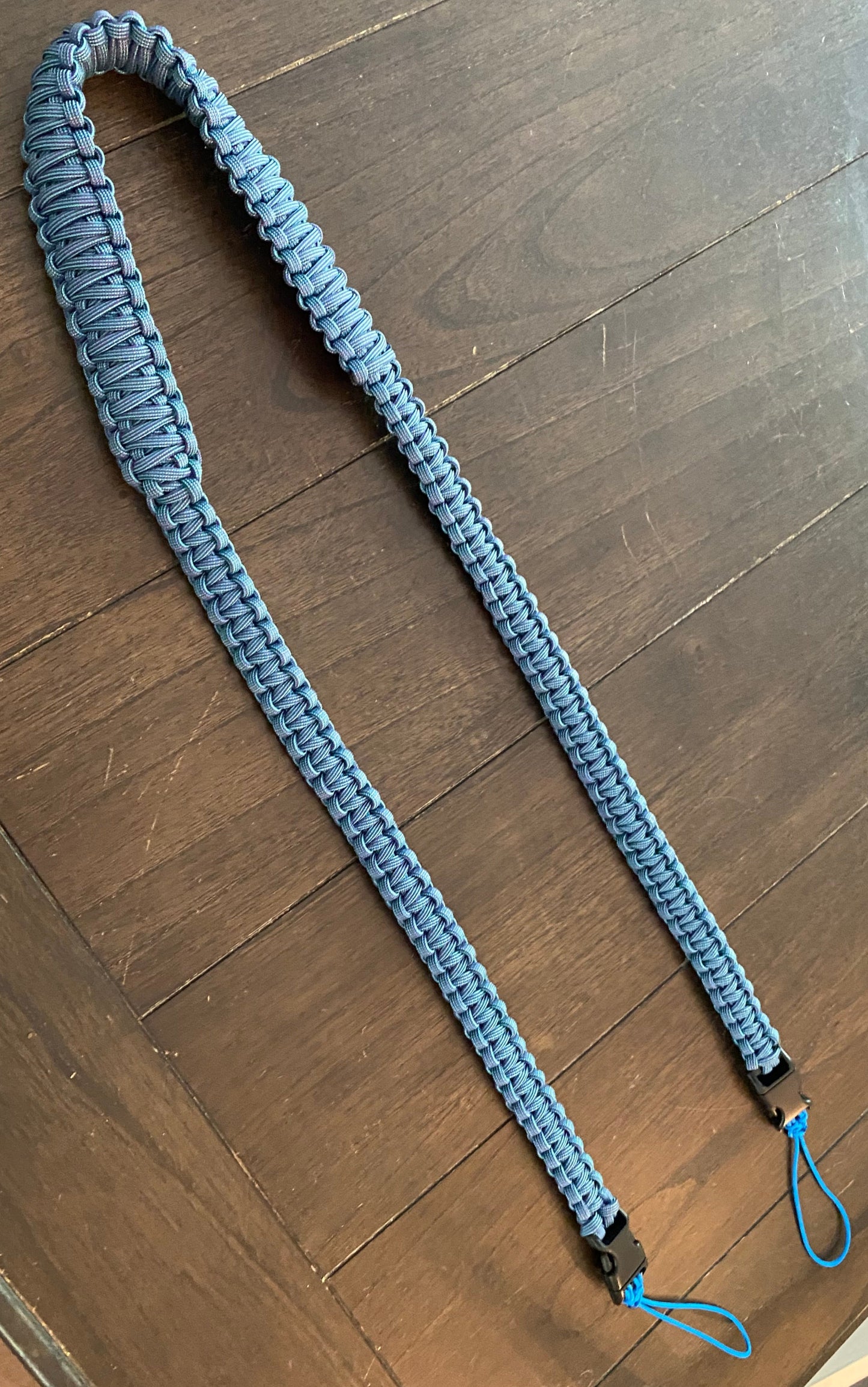 a cobra knot binocular lanyard crafted using 550 paracord and the cobra knot