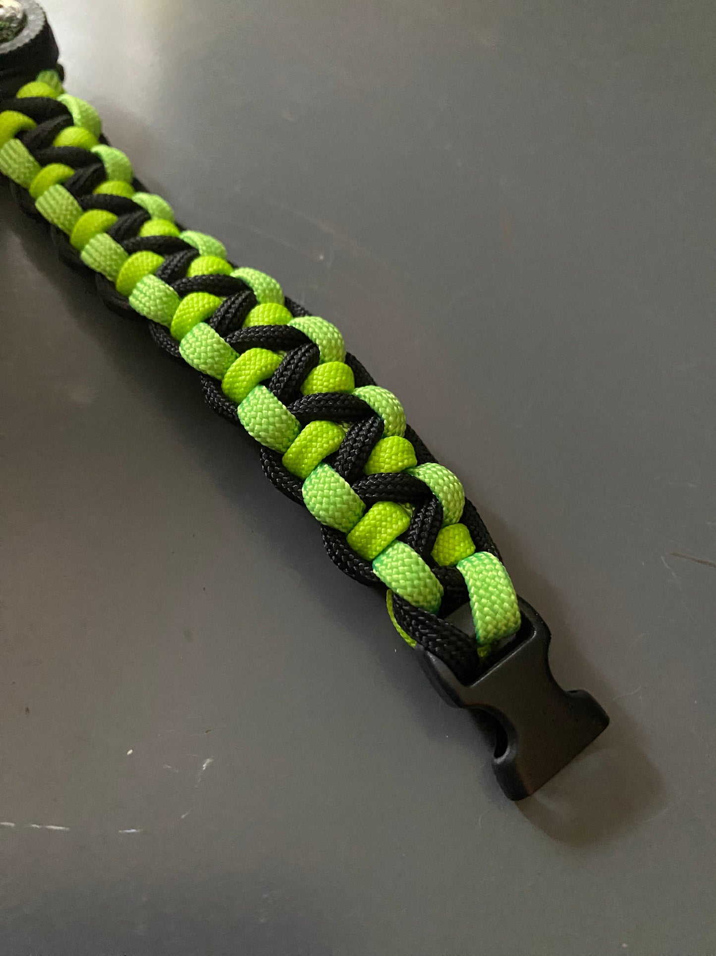 a soloman's dragon paracord bracelet crafted with green and black 550 paracord