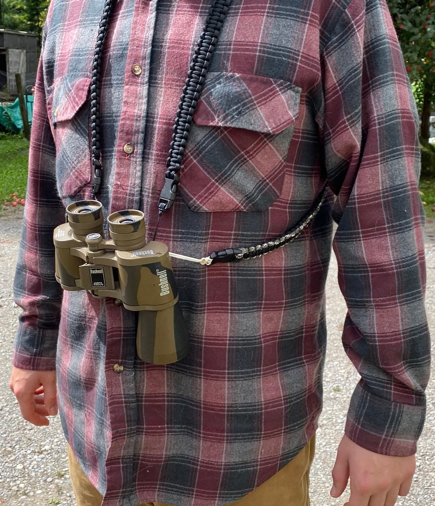 the front of a man wearing a paracord binocular harness