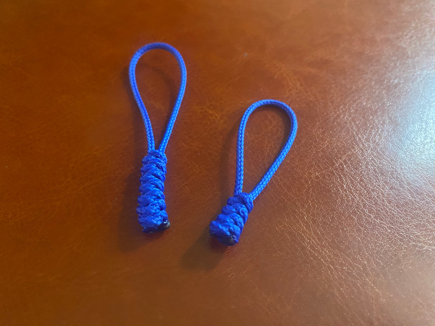 two snake knot zipper pull made with blue 95 paracord