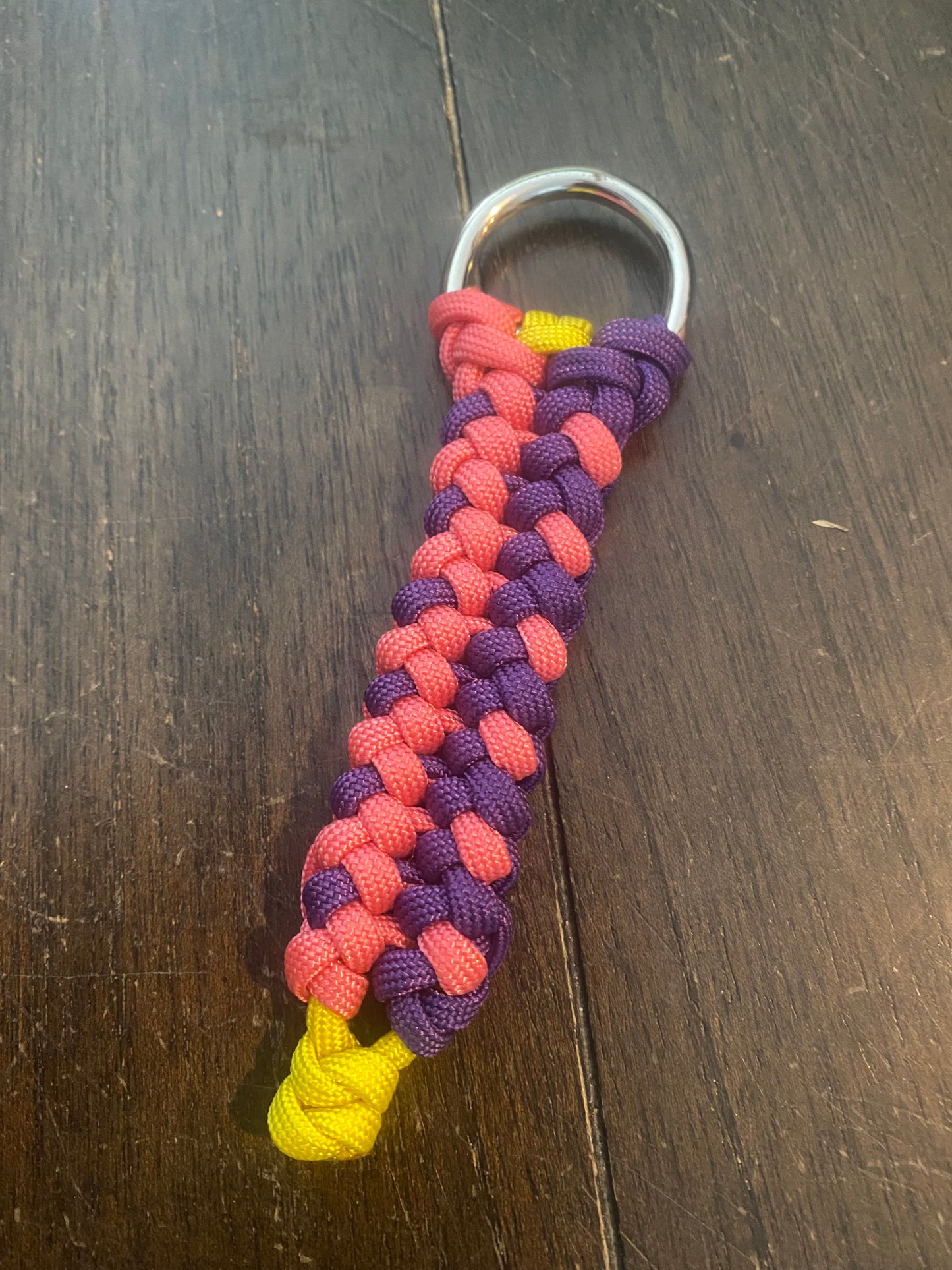 a sanctified key chain crafted in 550 paracord in pink and purple