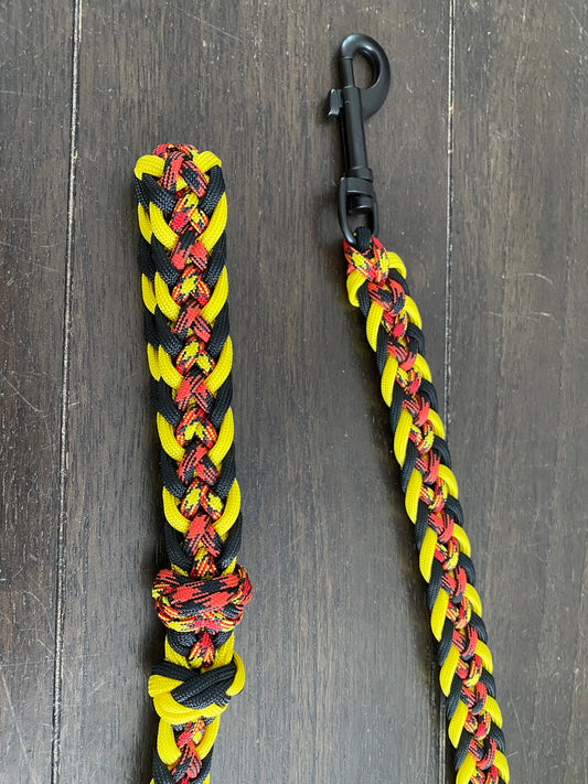 a traffic dog leash made in the Japanese flat weave with yellow, black, red and patterned paracord in matching colors