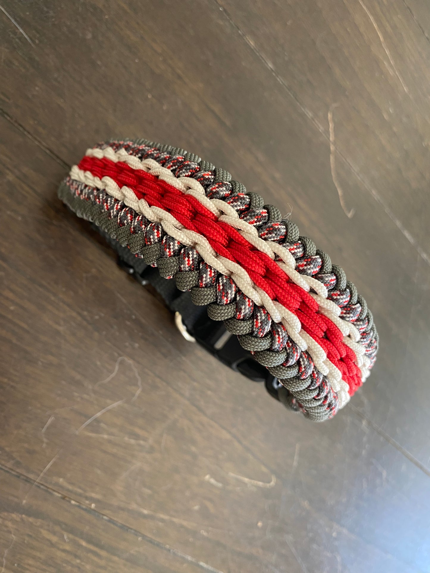 a fancy stitched modified sanctified dog collar made in grey and patterned grey-and-red-and-white 550 paracord, and white and red 275 cord.