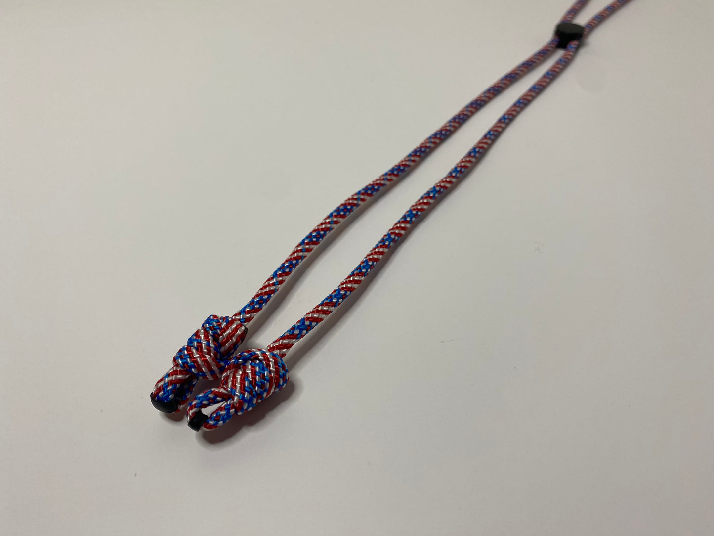 a single eyeglass retainer in patriotic red, white, and blue colors.