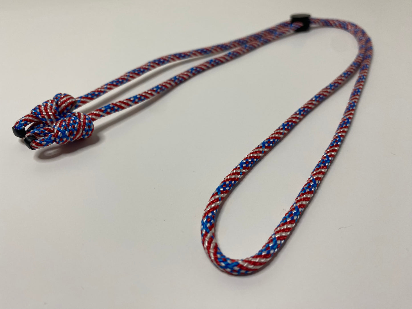 a single eyeglass retainer in patriotic red, white, and blue colors.