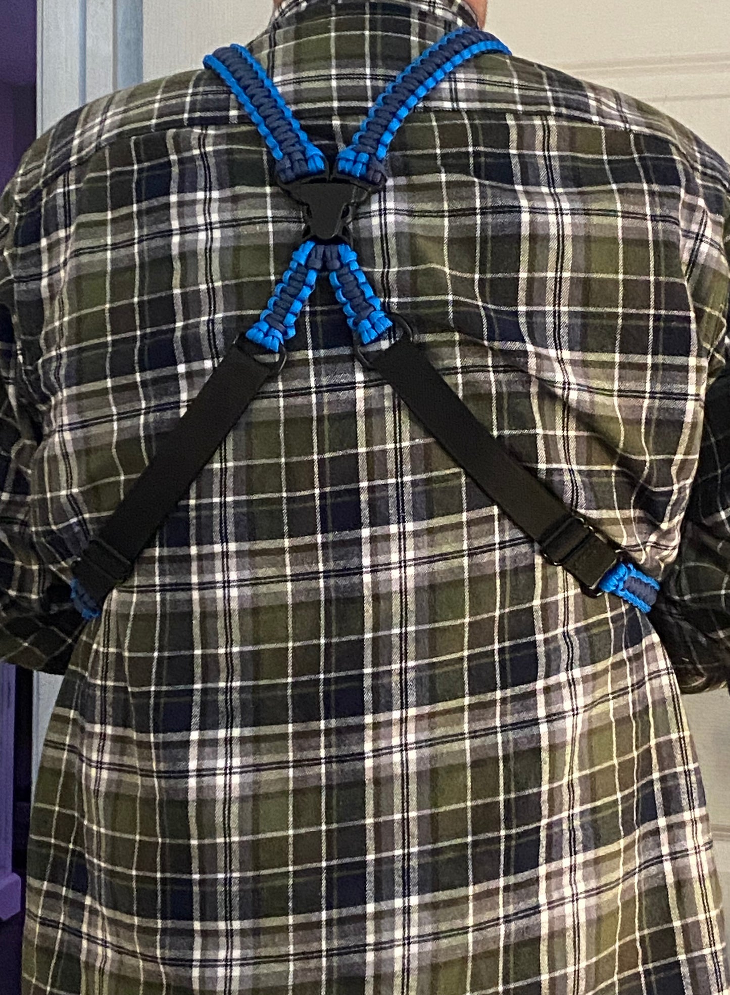 the back of an adjustable binocular harness made with paracord and black nylon webbing.