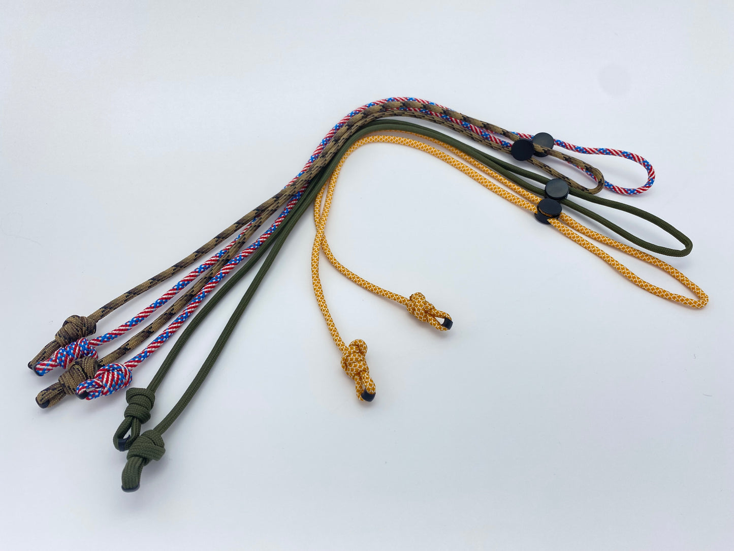 several paracord eyeglass retainers sitting on a clean white background.