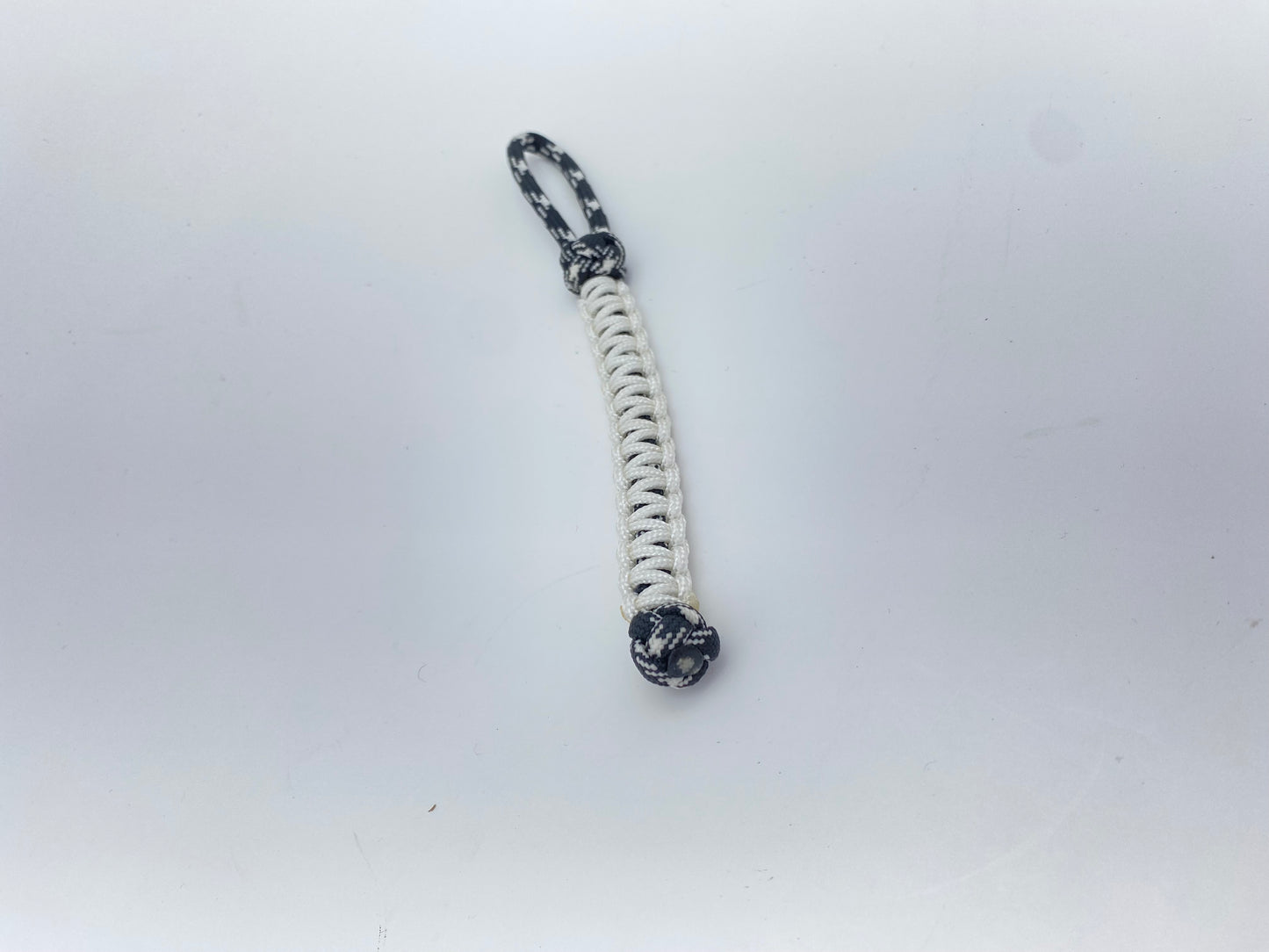 a small paracord knife lanyard made with glow-in-the-dark tracer 550 cord and glow-in-the-dark 95 cord.