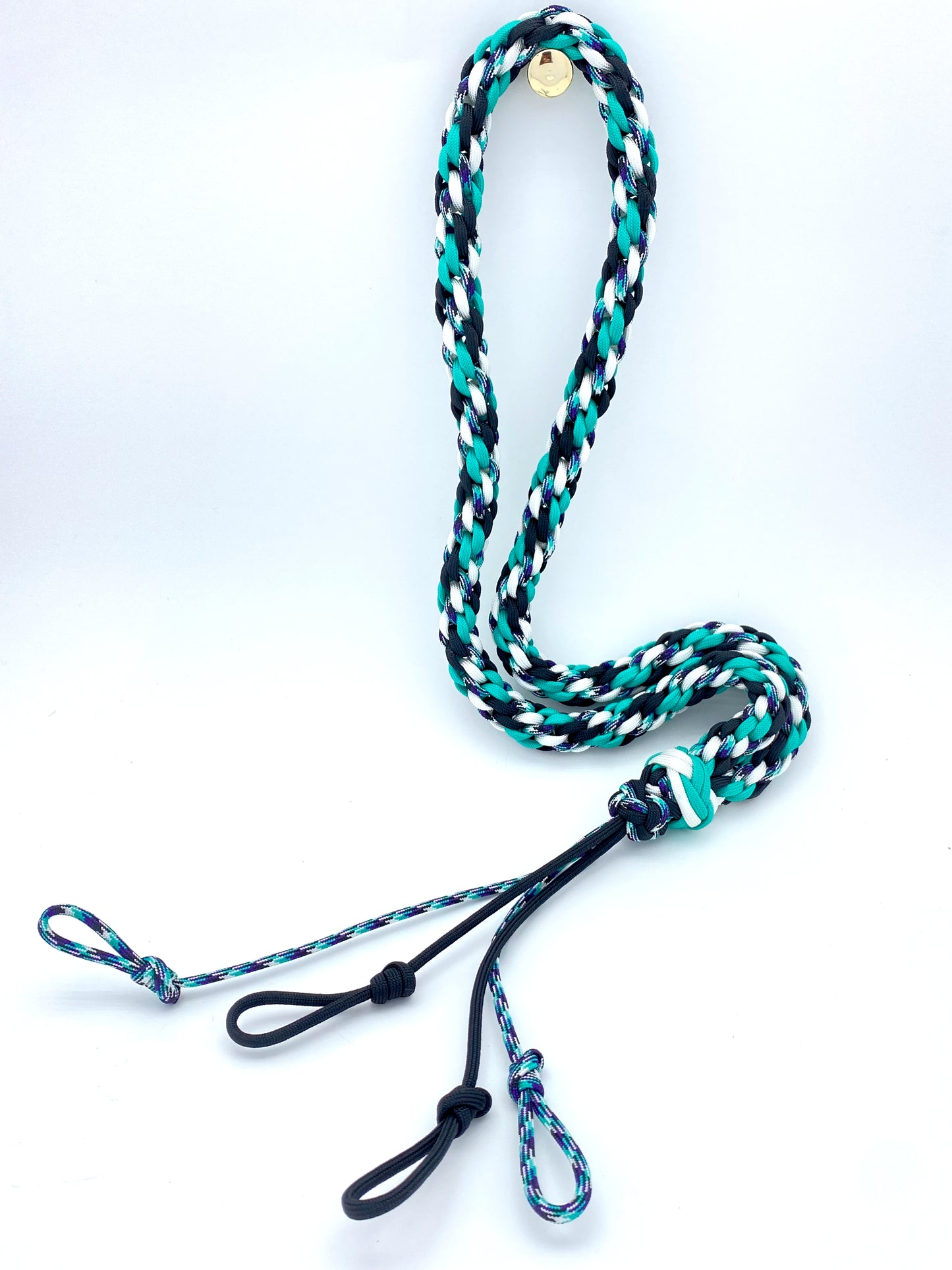 a handcrafted hunting lanyard for predator or prey calls built with black, white, and purple 550 paracord