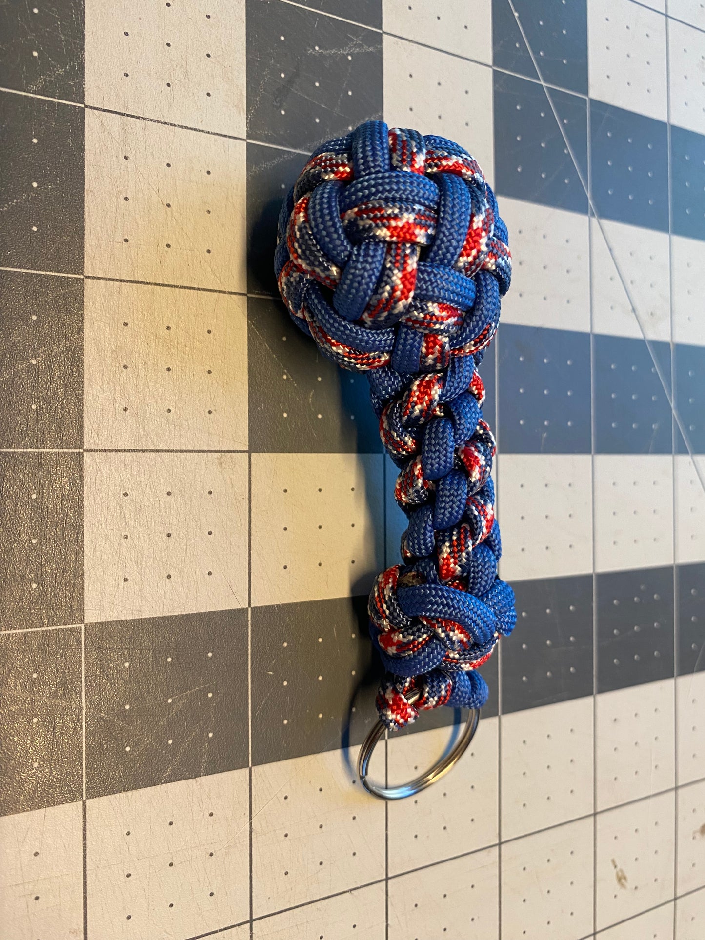 a key fob made crafted with many fancy knots like a footrope knot and a globe knot