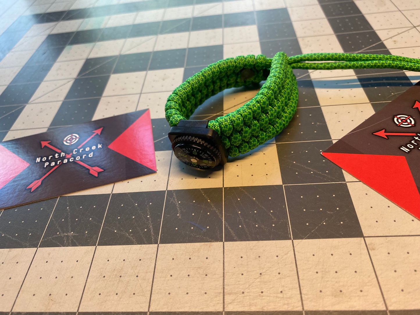 an adjustable trilobite bracelet built with green diamond paracord and a compass