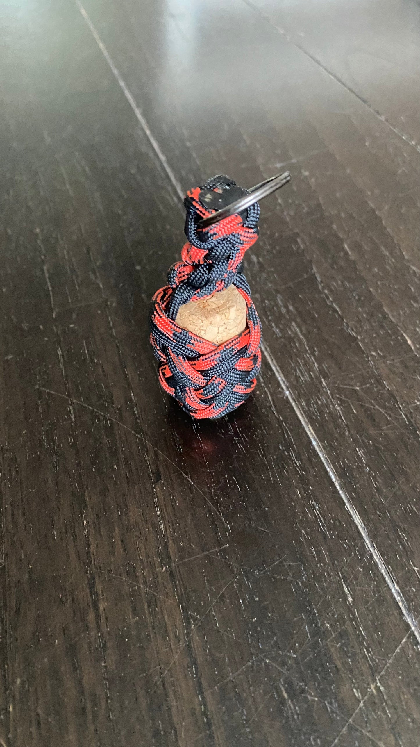 a boat key chain that floats crafted in red and black 550 paracord