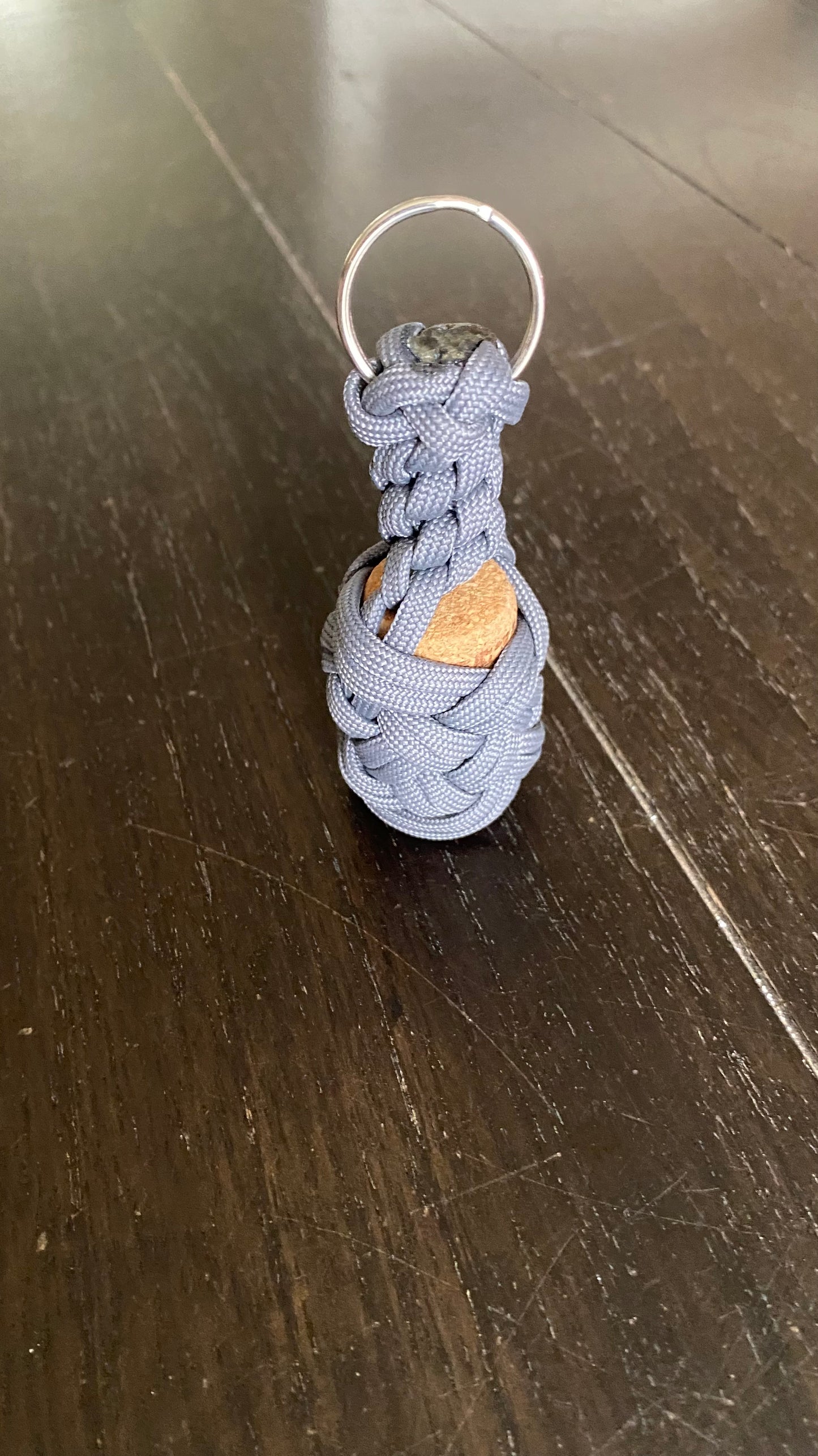 a boat key chain that floats crafted in grey 550 paracord