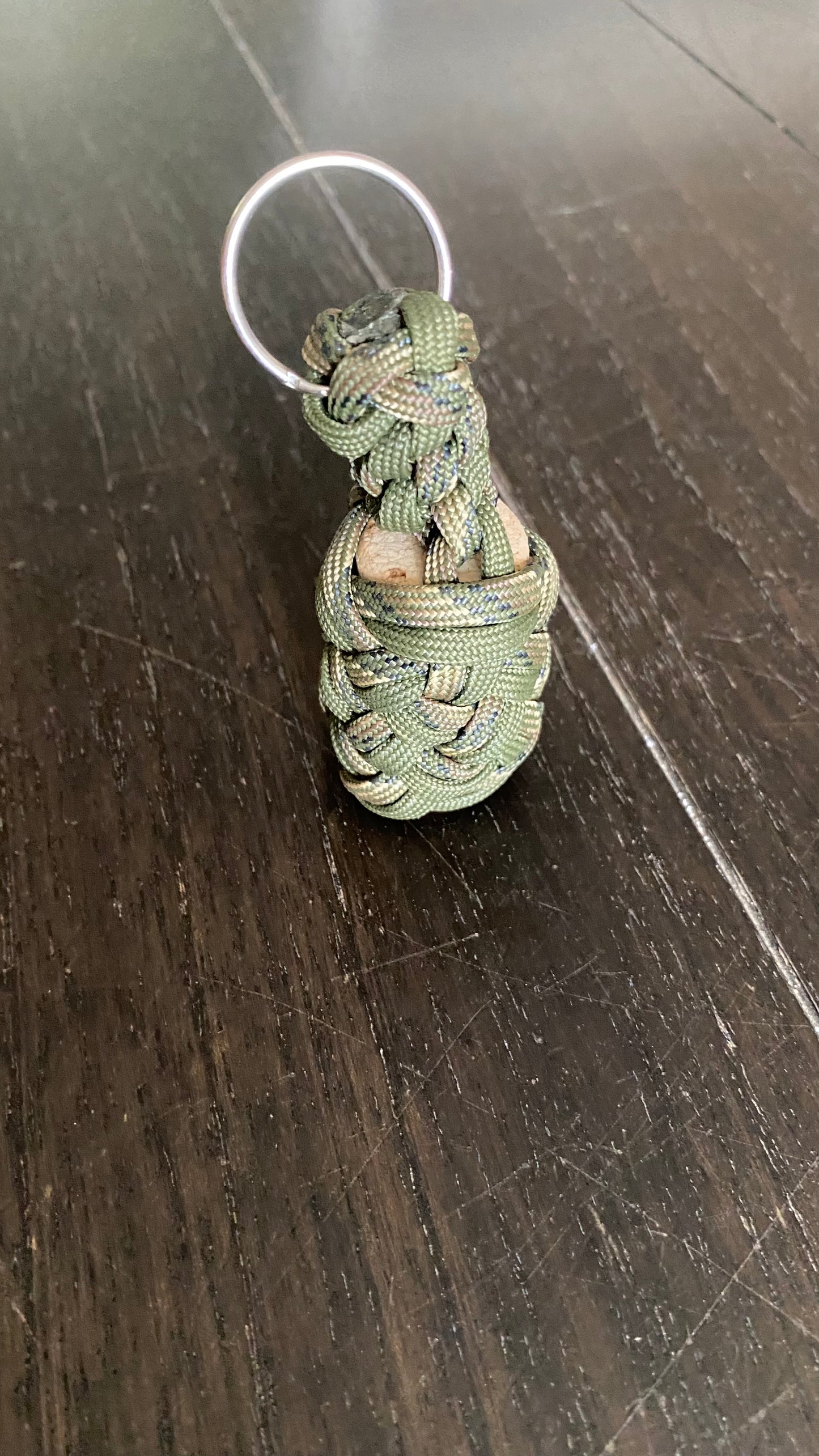 a boat key chain that floats crafted in camo and OD green 550 paracord