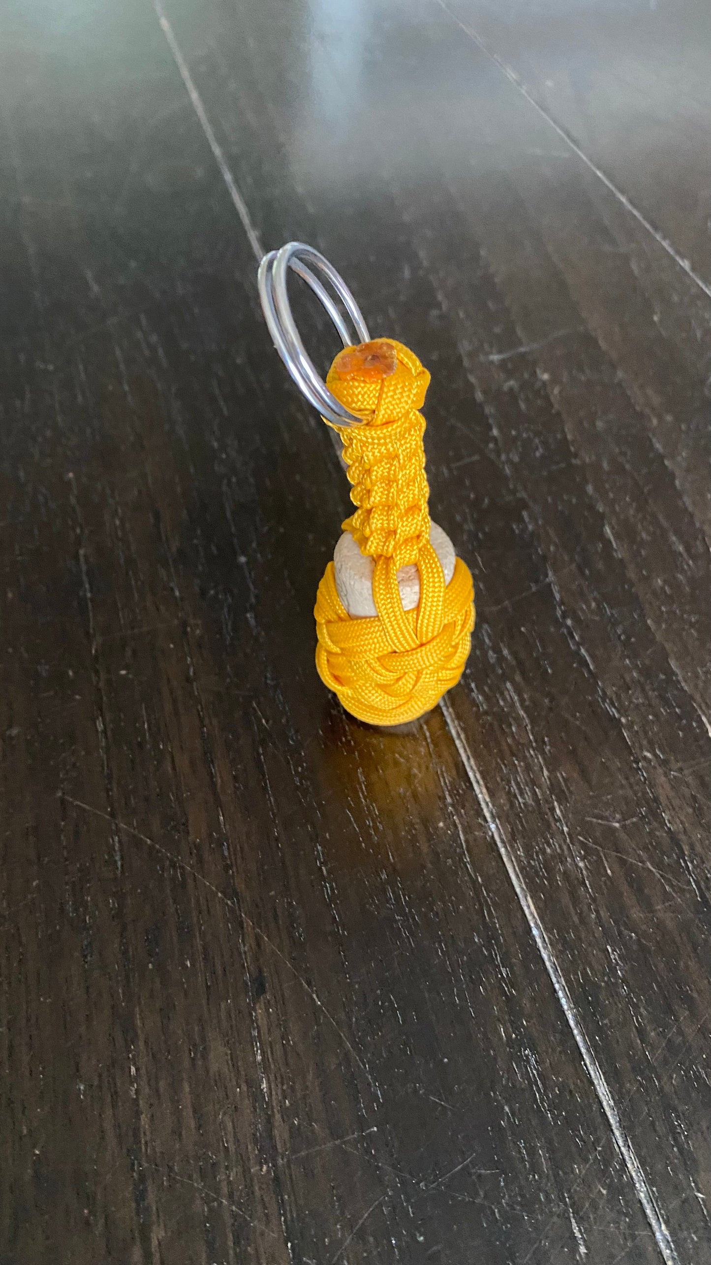 a boat key chain that floats crafted in flattened gold 550 paracord