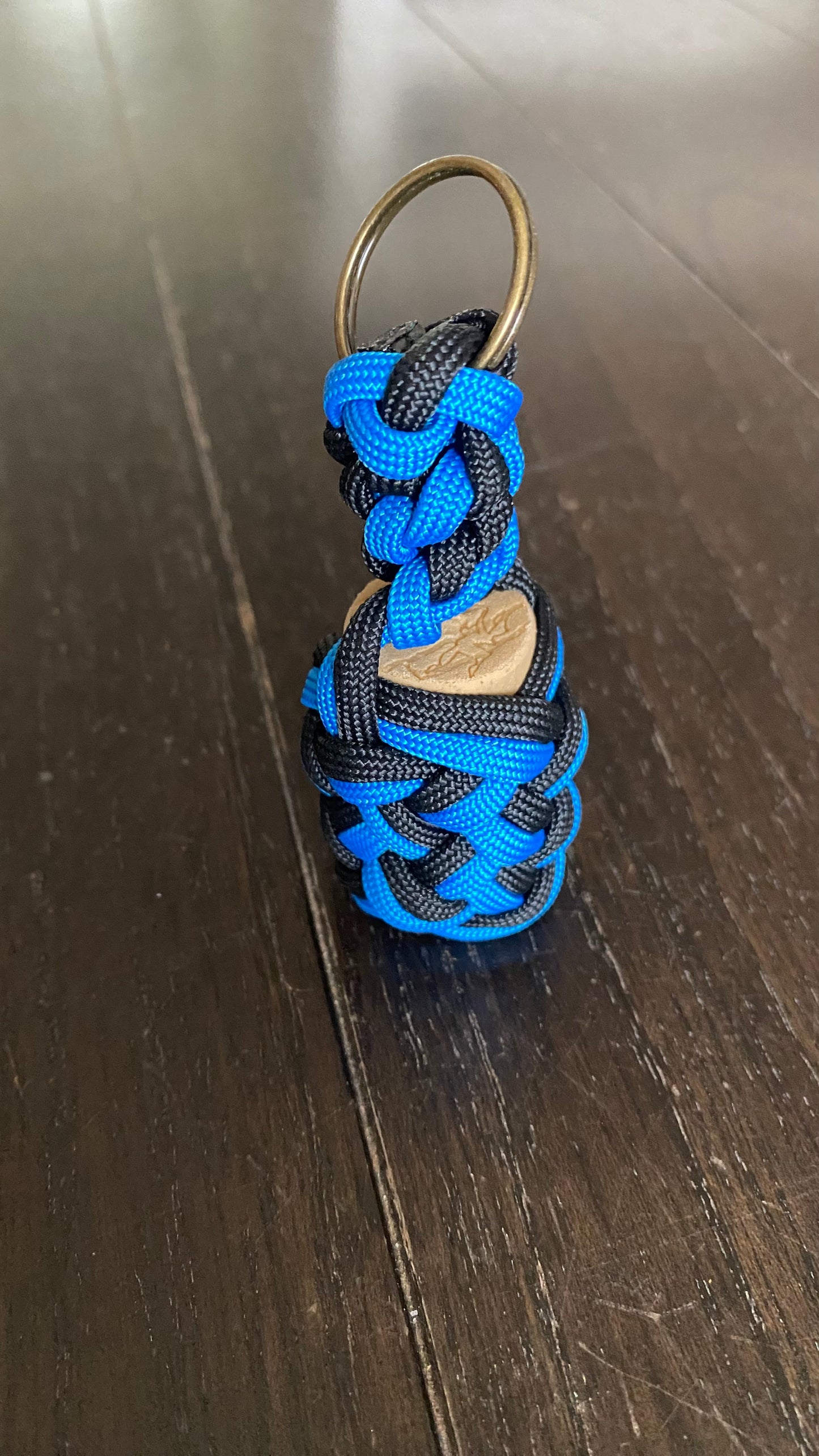 a boat key chain that floats crafted in black and blue 550 paracord
