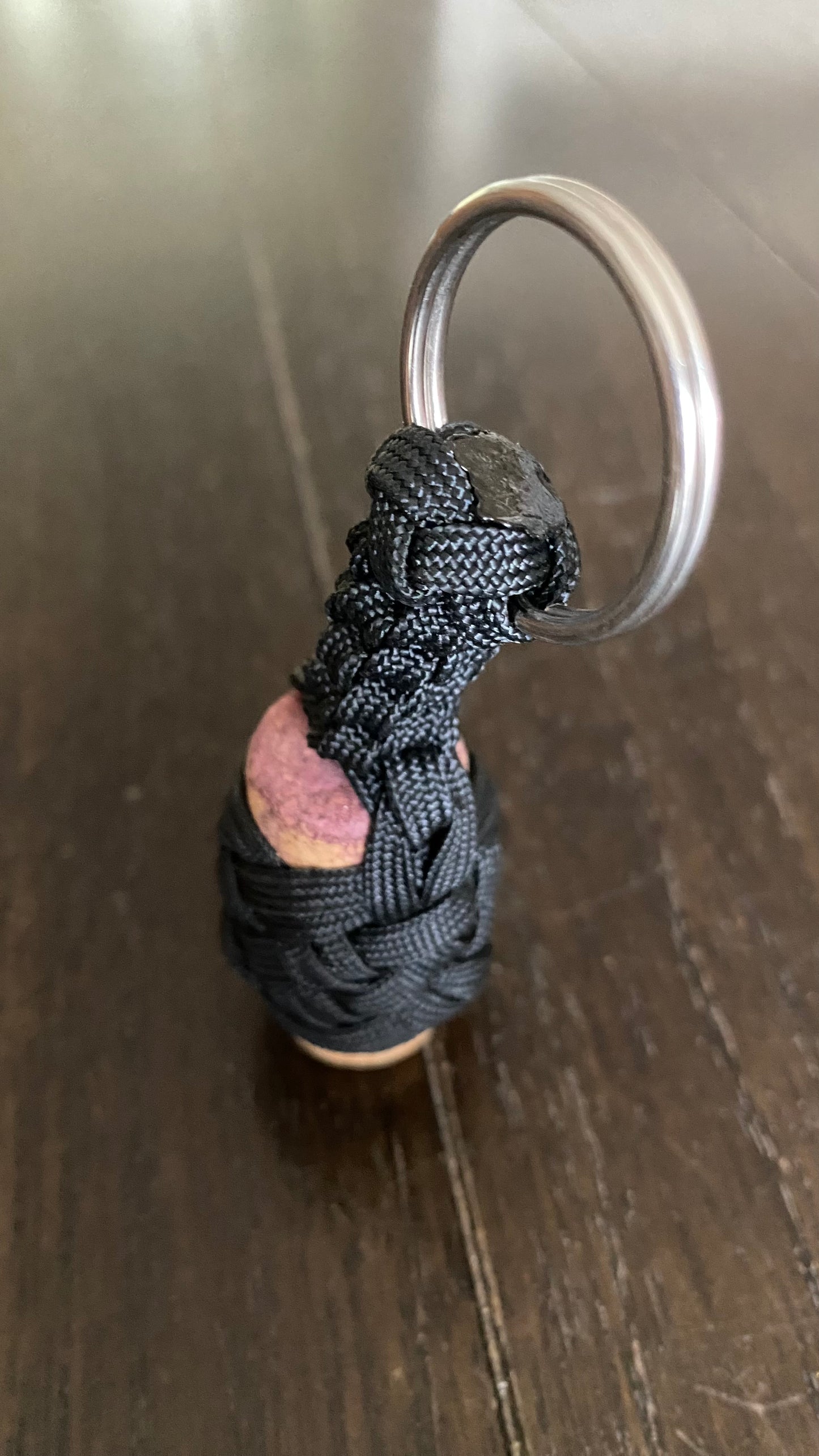 a boat key chain that floats crafted in black 550 paracord