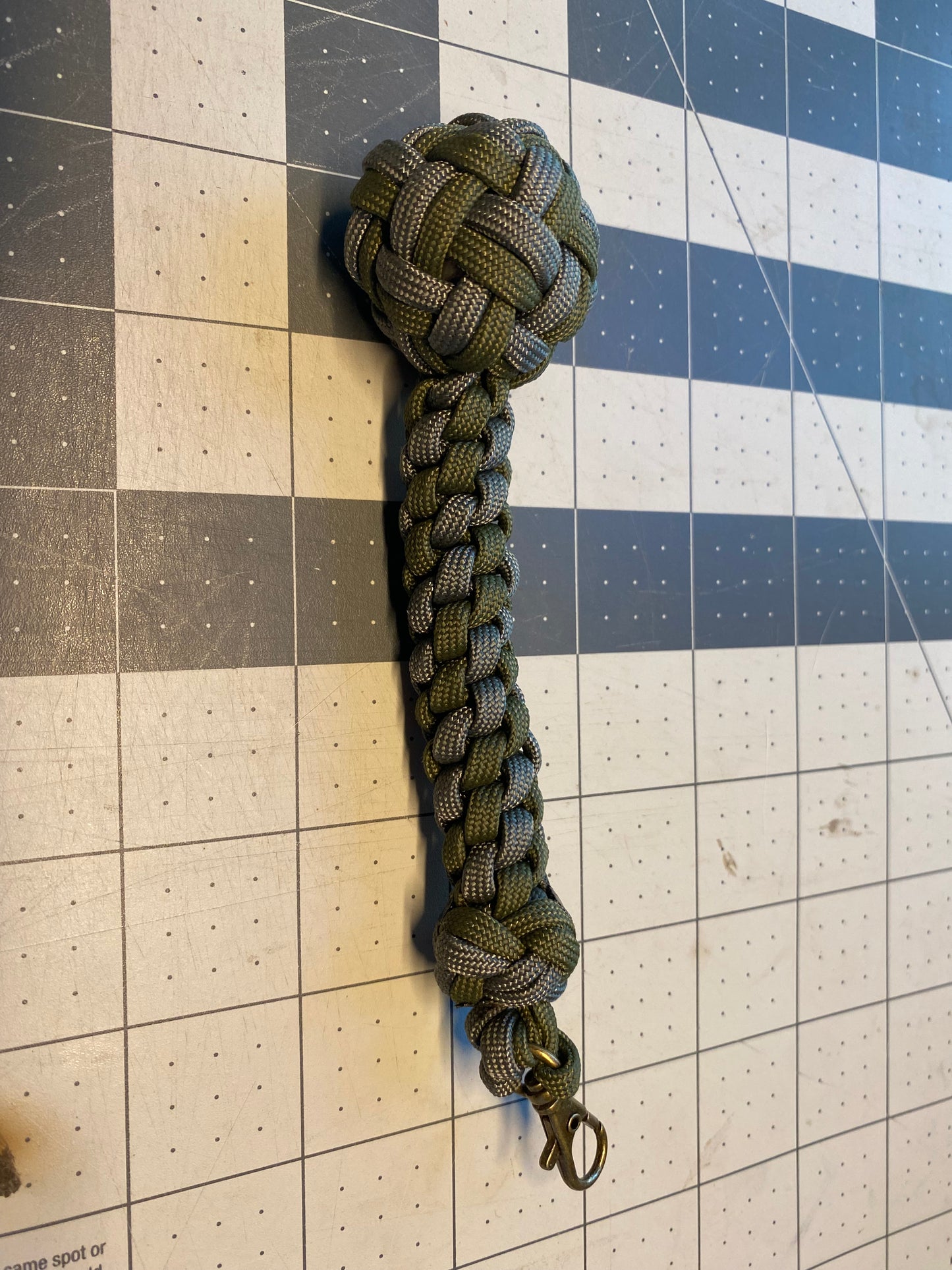 a key fob made crafted with many fancy knots like a footrope knot and a globe knot