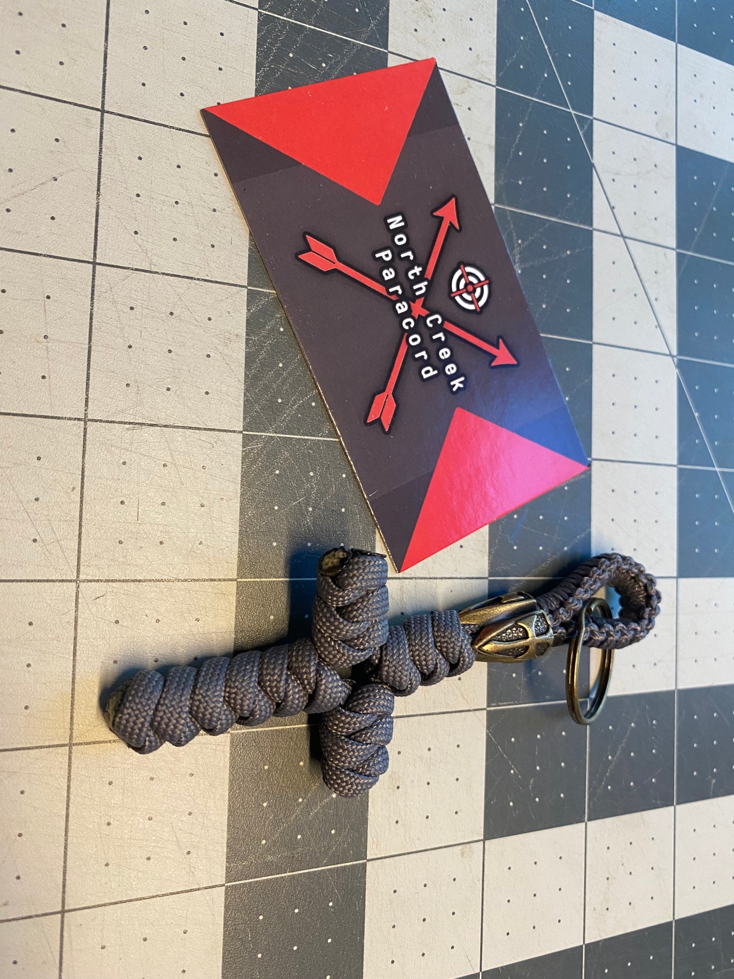 a key fob crafted with a lanyard bead and a snake knot cross