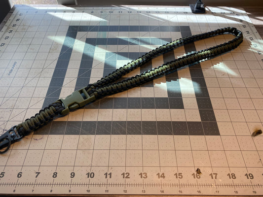 a tactical general lanyard crafted in the cobra weave with a OD green and black color scheme