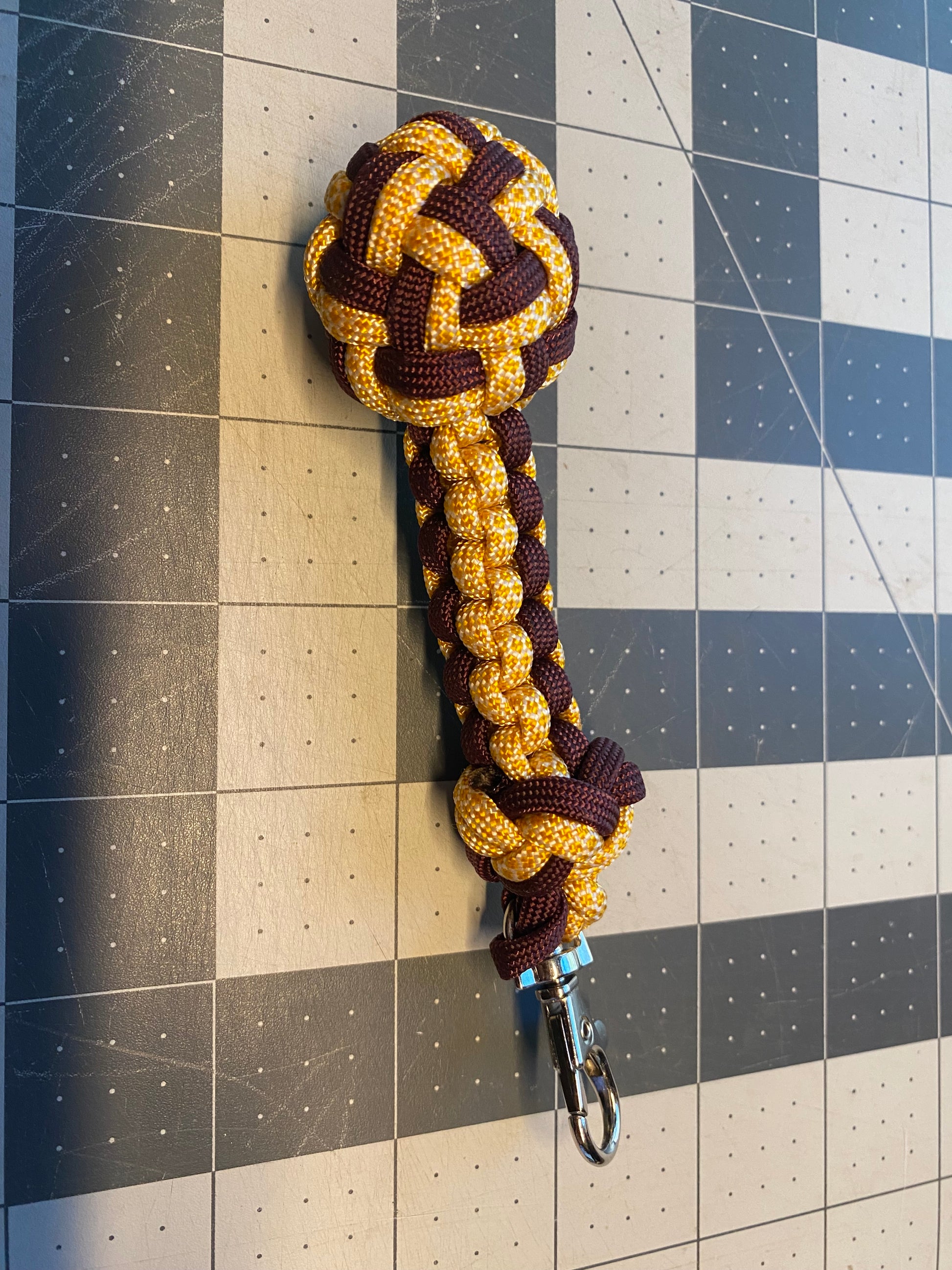 a key fob made crafted with many fancy knots like a footrope knot and a globe knot