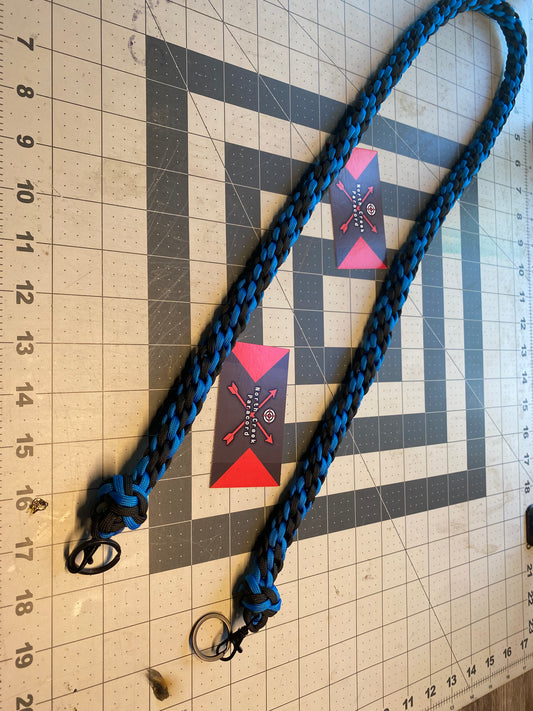 a binocular lanyard crafted with the Japanese round braid in blue and black and black hardware