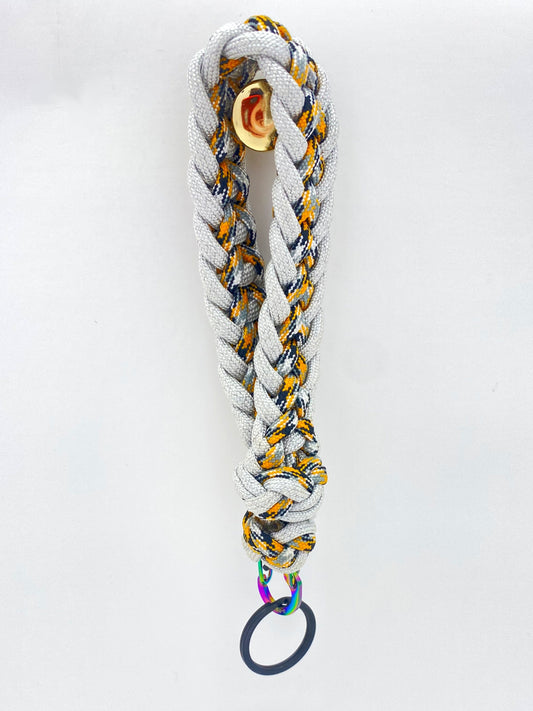 a wristlet crafted in the Japanese flat weave, finished with a foot rope knot, and made with magnesium and craftsman 550 paracord