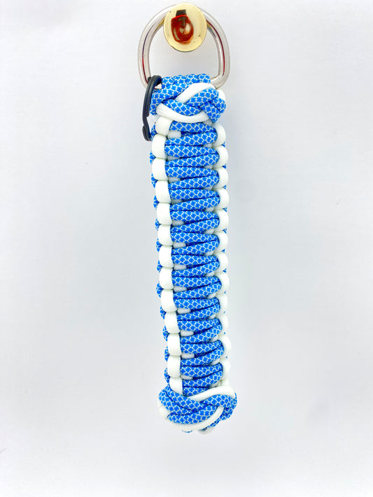 one side of a king or double cobra woven key chain finished with two footrope knots and built with white and blue paracord