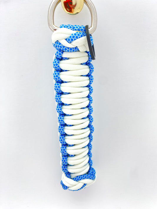one side of a king or double cobra woven key chain finished with two footrope knots and built with white and blue paracord