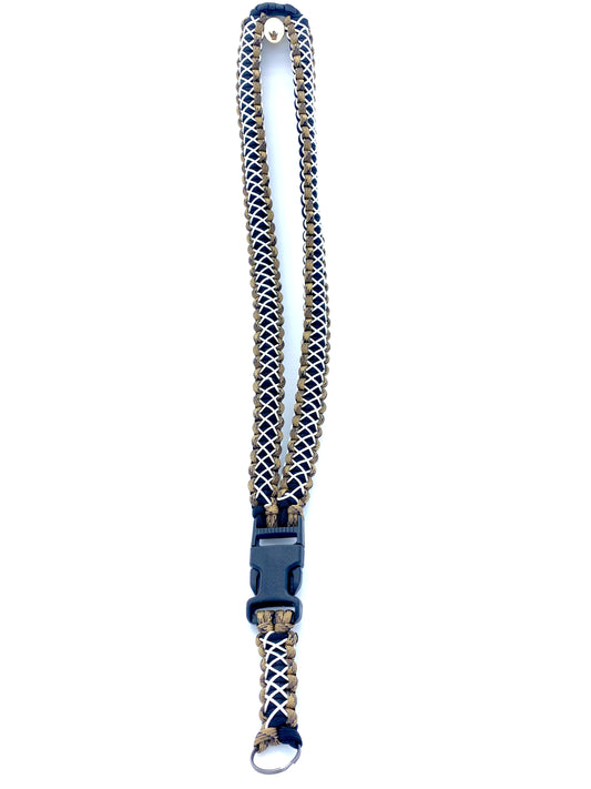 a paracord neck lanyard made with FDE camo and black paracord and stitched with white microcord.