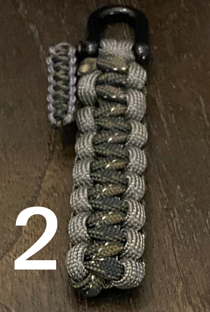 a shackle keychain crafted in a cobra weave and 550 paracord
