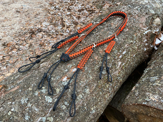 a brown, black, orange game call lanyard made with 550 paracord and four additional loop add-ons.