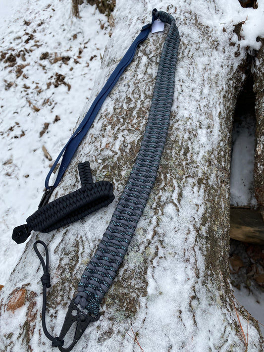 a trilobite drill-less rifle sling crafted with graphite and canis 550 paracord.