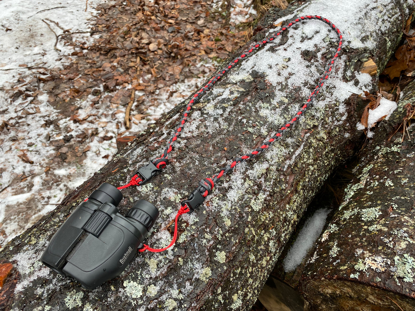 a 4-strand binocular lanyard attached to binoculars.