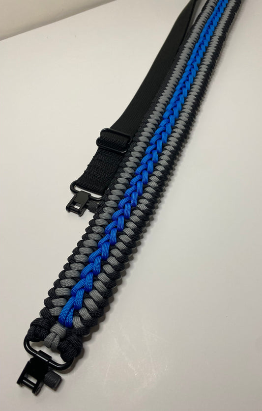 a paracord rifle sling with trilock swivels made in gray, black, and blue paracord woven in the modified sanctified weave.