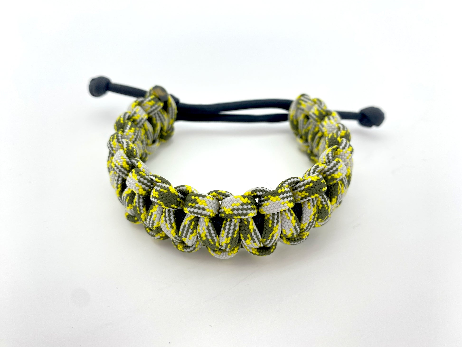 an adjustable cobra 550 paracord bracelet made with black and multicolored yellow, gray, and olive green paracord