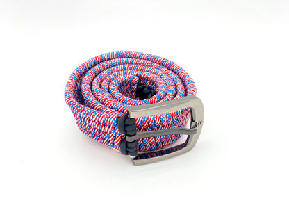 a 550 paracord belt woven in red, white, and blue multicolored paracord on a gray metal 1-inch belt buckle.