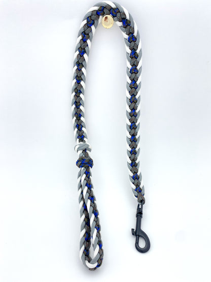 a fancy paracord leash made out of 550 paracord in various blues, grays, and white